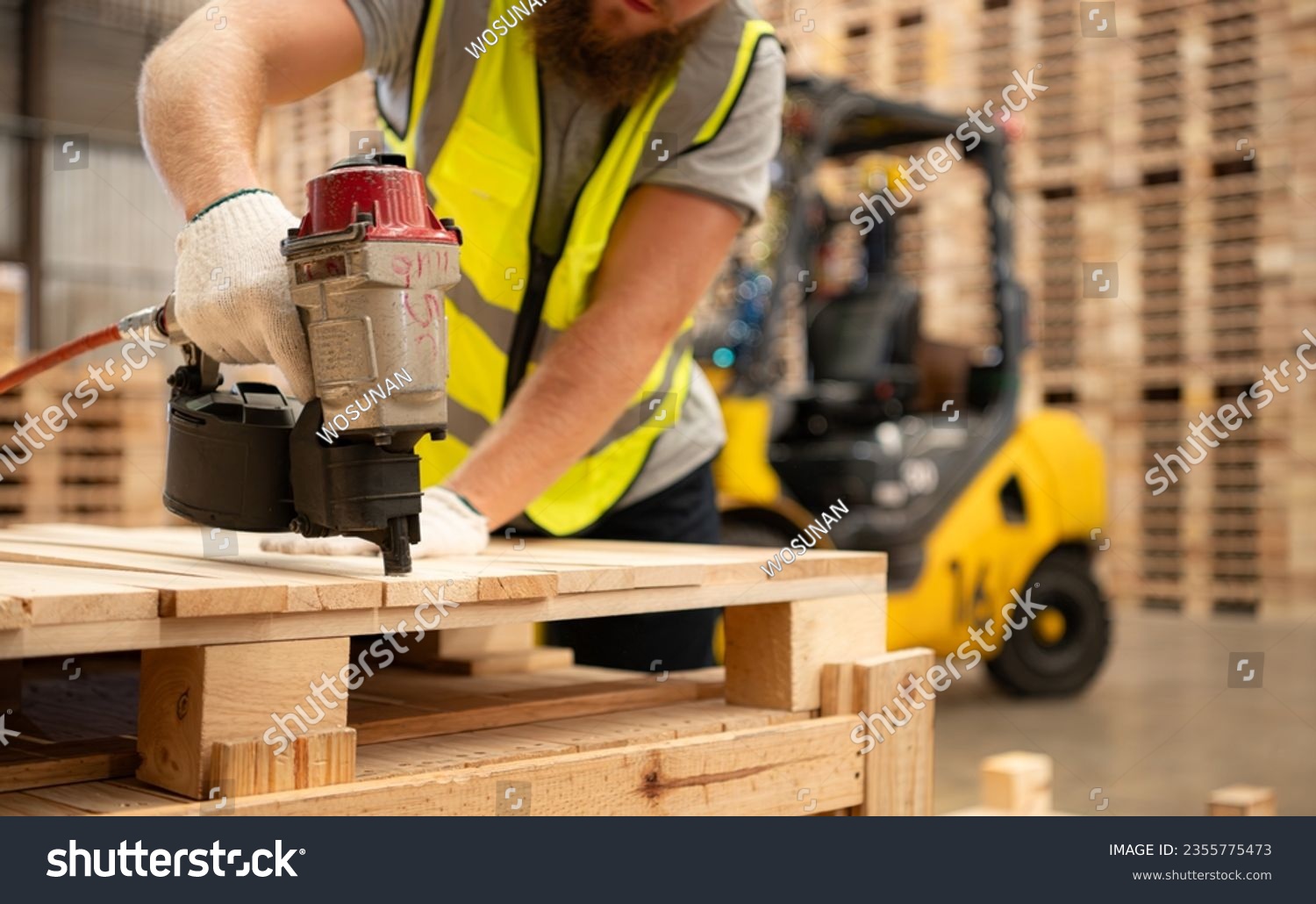 Workers assembling wooden pallets